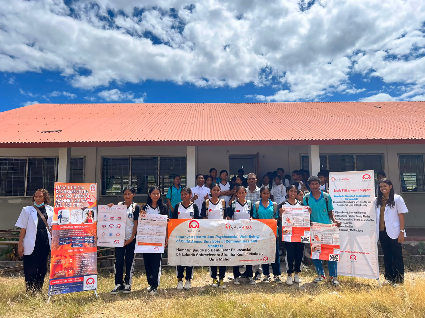 Students and Casa Vida team with health and child protection materials